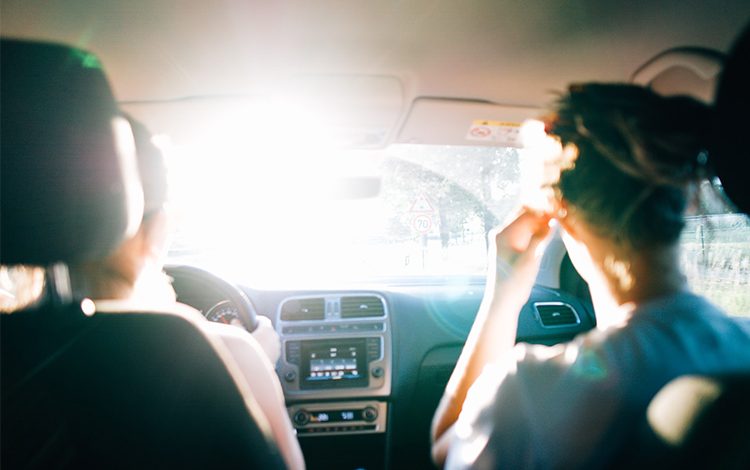 A person sitting with his friend in car getting their arabic translation abu dhabi driving license