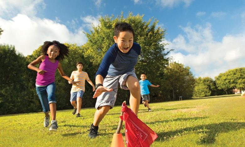 kids playing capture the flag in a park