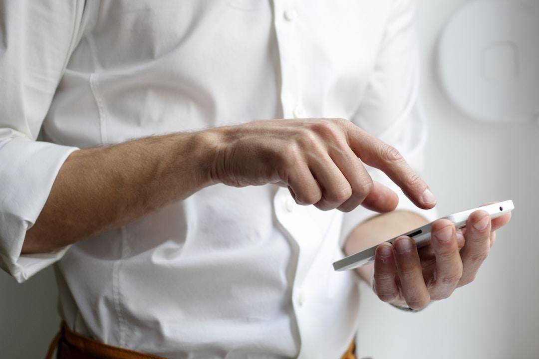 Manager evaluating a sales enablement app on a smartphone for team deployment